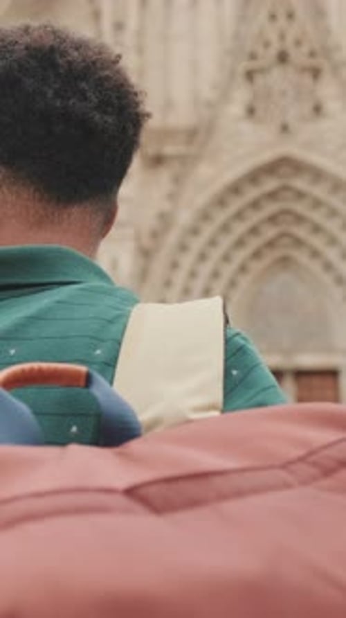 Close-up of young man tourist with backpack on his shoulder, looking at the sights