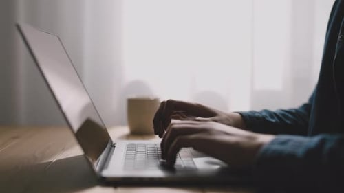 Typing on Laptop at Home at Desk