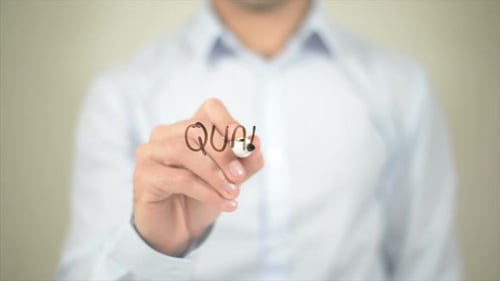 Man Writes Quality Assurance on Clear Surface