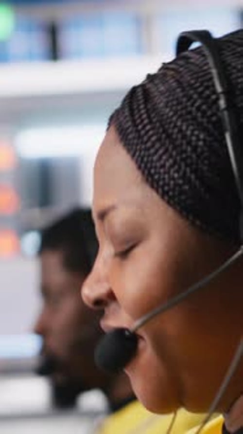 Adults Wearing Headsets Working at Computers
