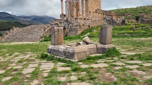 Revealing shot of Roman Severan temple ruins in Djemila Algeria on a cloudy day