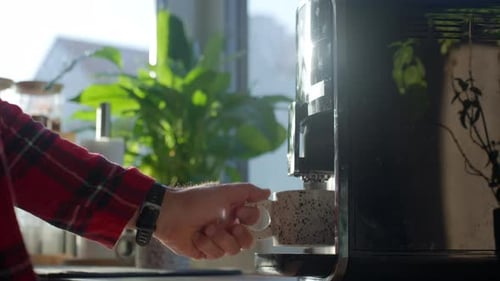 Person Prepares Coffee with Espresso Machine in Kitchen