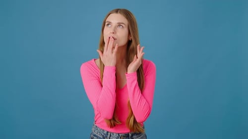 Beauty Long Haired Woman in Pink Shirt Corrects Her Hairstyle and Looking at the Camera