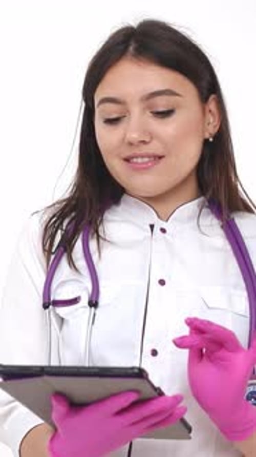 Female Doctor Uses Tablet in Clinical Setting