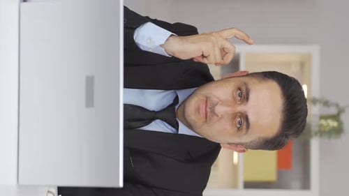 Vertical video of Home office worker man expressing his mind and success to the camera.