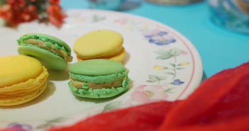 Green and Yellow Macarons on a Floral Plate