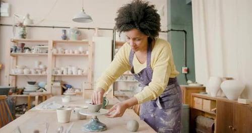 Female Artist Crafting in Pottery studio with Creative focus.