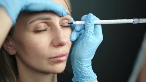 Process of Putting Marks on Upper Eyelid of Young Woman for Plastic Surgery