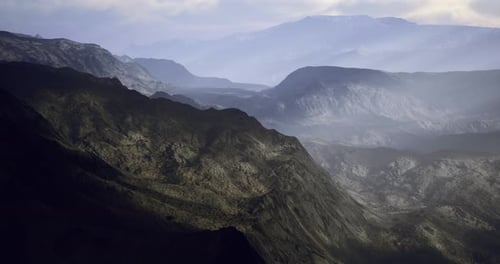 Majestic Mountain Landscape with Layered Hills Under Soft Sky Light