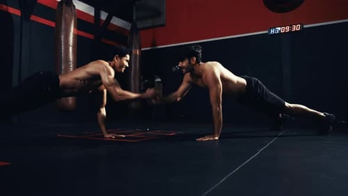 Sportsman workout together exercise push-ups crossfit in the fitness gym healthy lifestyle