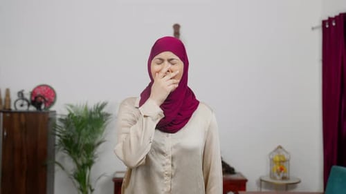 Woman reacts to a bad odor indoors