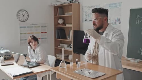 Chemistry Demonstration by Teacher with Purple Solution
