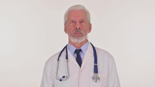 Senior Doctor with Stethoscope Standing Still