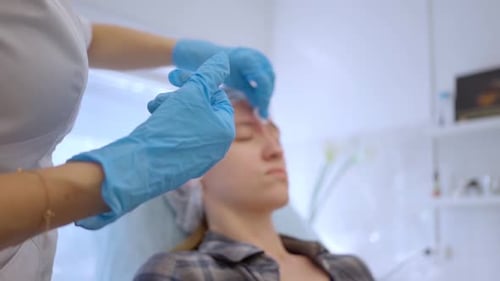 Female Patient Receiving Cosmetic Injection in Clinic
