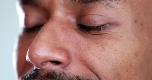 Close-up black african man face eyes looking pensive