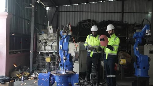 Engineer work at robotic arm factory.