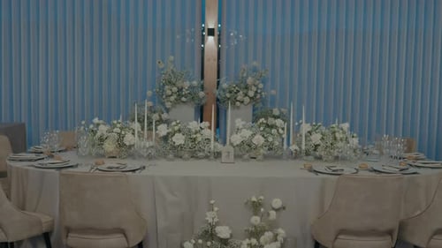 Wedding Reception Table Setup with White Flower Arrangements