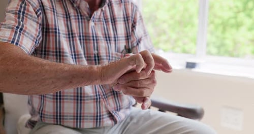 Senior Man Rubbing Hands for Pain Relief