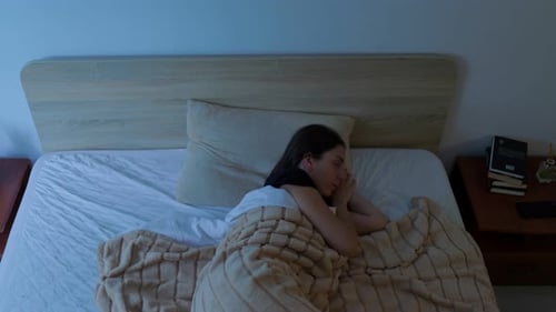 Woman Sleeping Peacefully in Bed at Night
