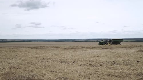 Tractor Harvesting Crops in Rural Farmland