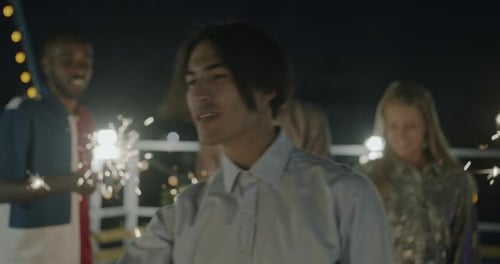 Diverse Friends Celebrating at Night with Sparklers