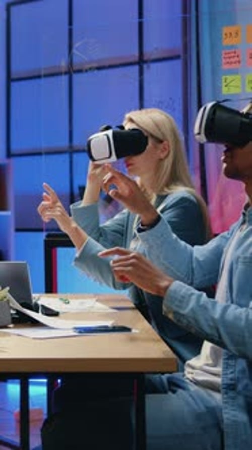 Colleagues Using VR Headsets in Modern Office