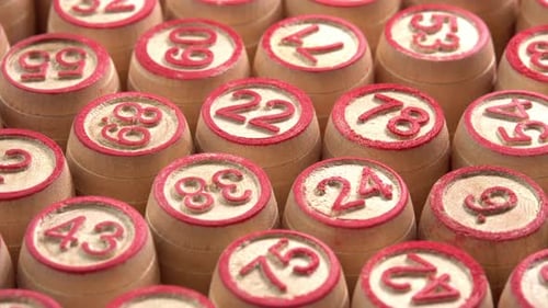 Lotto board game with wooden barrels with numbers rotate background in macro side view sun light