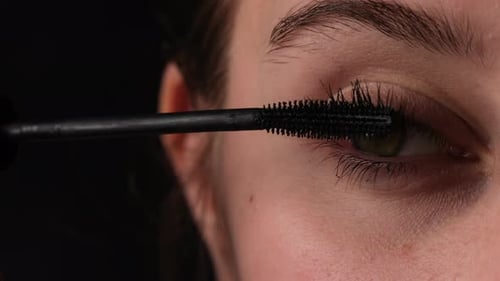 Female Professional Makeup Girl Using Black Mascara On A Eyelashes Close Up