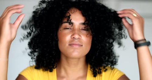 Woman with Curly Hair Styles Her Hair