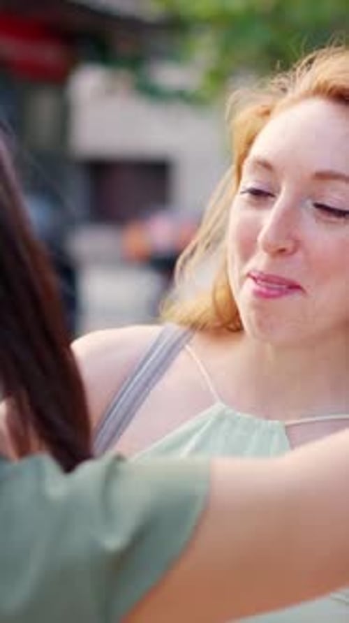 Smiling Friends Embrace Effusively at a Meeting