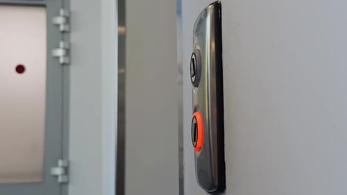 CloseUp View of a Modern Elevator Button Being Pressed By a Female Finger