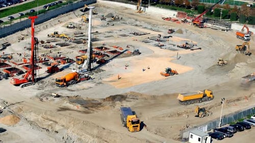 Busy Construction Site Aerial View with Heavy Machinery