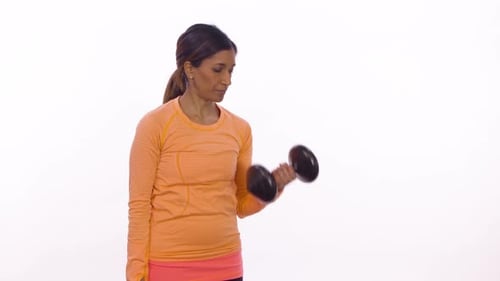 A woman does bicep curls. Wide shot on white background.