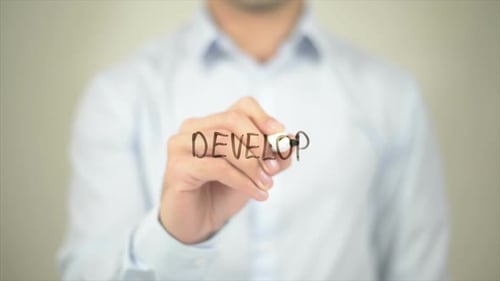 Writing the Word Develop on Transparent Surface