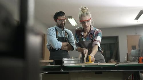 Carpenters are working together at workshop.