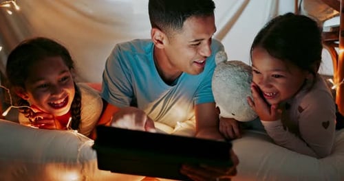 Father and Children Enjoy Tablet in Cozy Fort