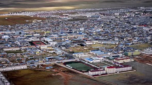 qinghai yushu - Mar 14, 2023: A drone view over the desert town with mountains in the background