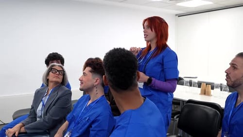 Medical Professional Gives Presentation to Group in Meeting Room
