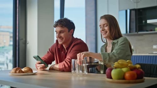 Couple Enjoying Coffee and Phone at Home