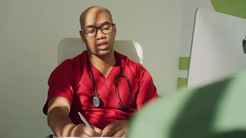 Young Adult Doctor Working at Office Desk