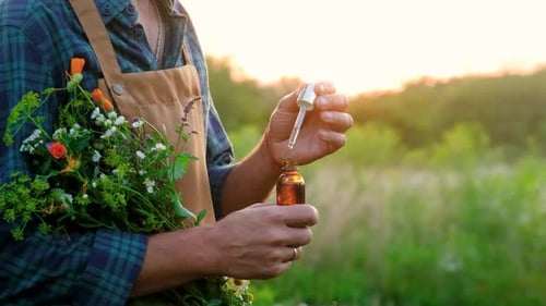 Man with Medicinal Herbal Extracts in His Hands Selective Focus
