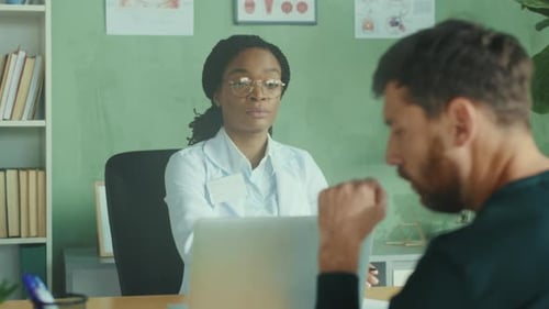 Female Doctor Consults with Patient in Office