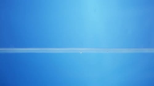 Mesmerizing Water Droplet Impact on Blue Surface