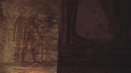 Slow motion travelling shot of a wall with hieroglyphs in the temple of Abu Simbel.
