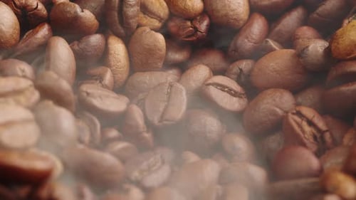 Roasting Coffee Beans with Smoke on Dark Background Close Up Arabica Robusta Colombian Beans