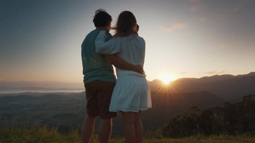 Couple Embracing at Sunset Over Mountain View