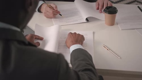 Business Partners Reading Contract and Shaking Hands