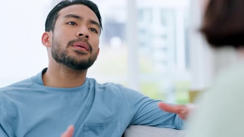 Young Man Talking and Gesturing During Conversation