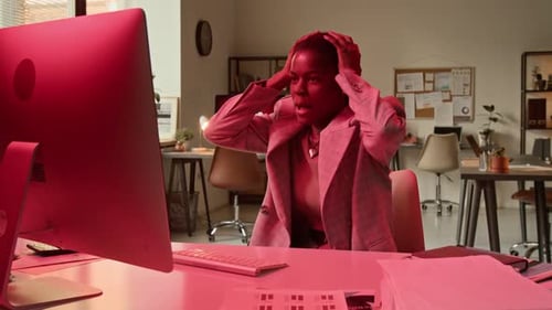 Woman Faces Computer Error at Office Desk