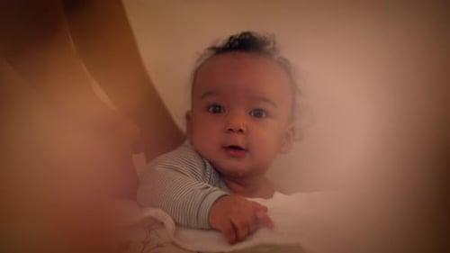 Adorable Baby Held by Caring Mother in Home